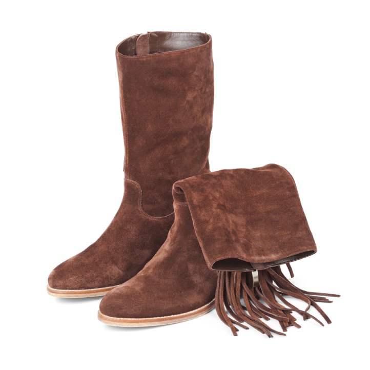 A pair of brown, suede fringe boots sit alone on a blank, white background. One of the boots has a bent top.